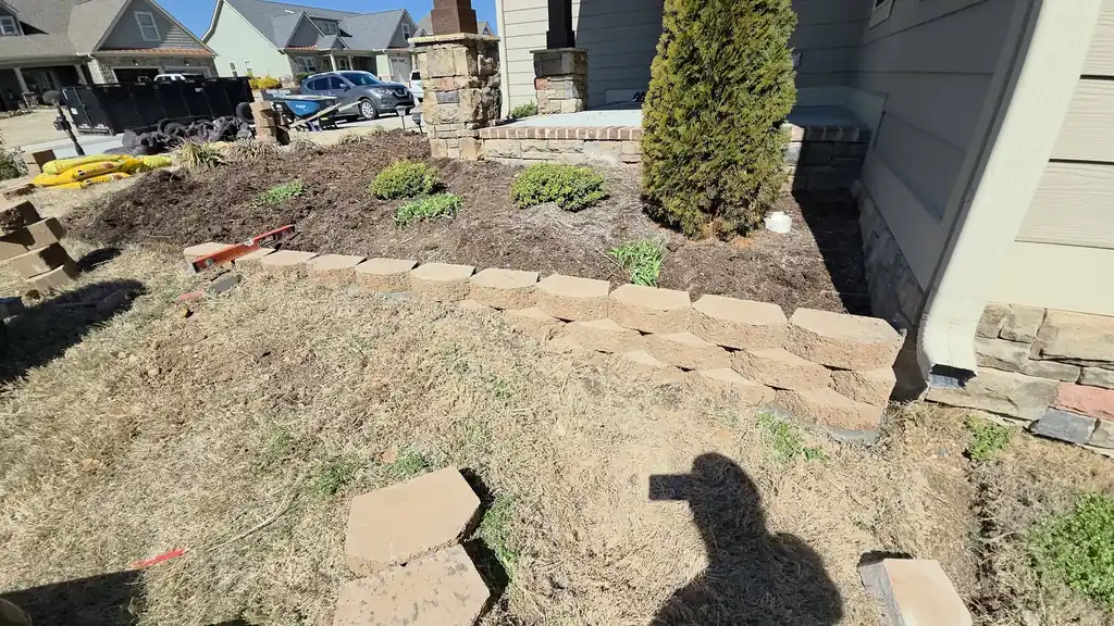 Mulch bed with stone edging and new plants in Cleveland, Tennessee