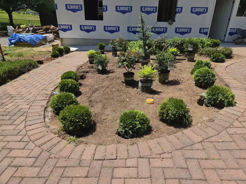 Brick paver circle with new plantings in the middle of a courtyard in Cleveland, Tennessee