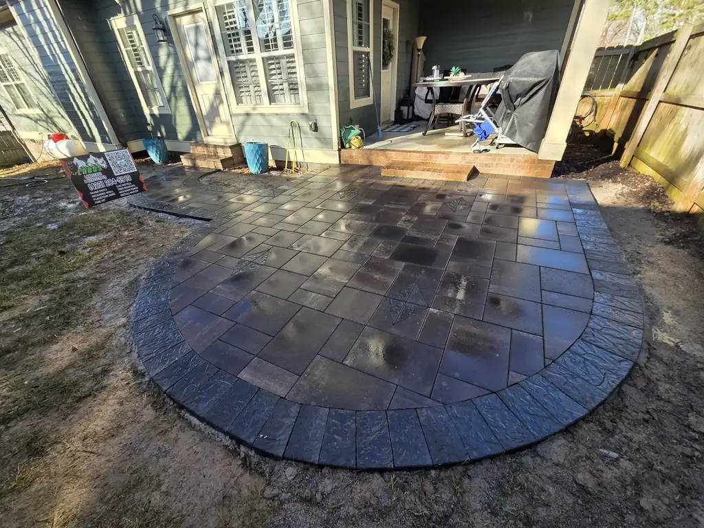 Dark circular paver patio with a charcoal border in Cleveland, Tennessee