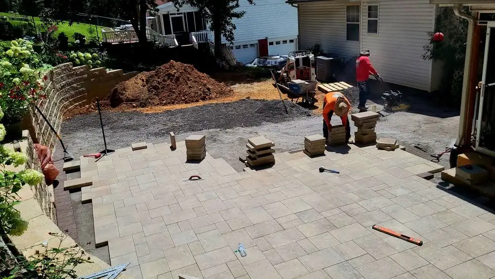 Paver patio being laid beside a garage in Cleveland, Tennessee