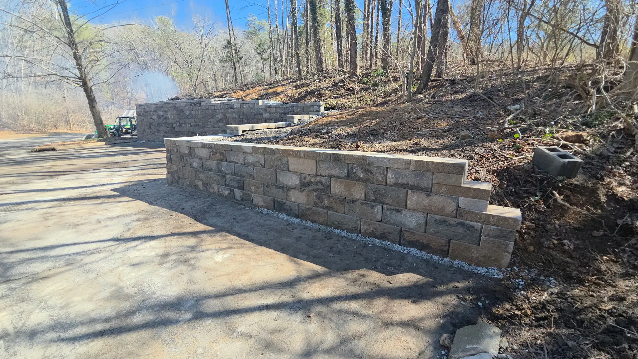 Finished block retaining wall holding a bank back along a wooded lot near Cleveland, Tennessee