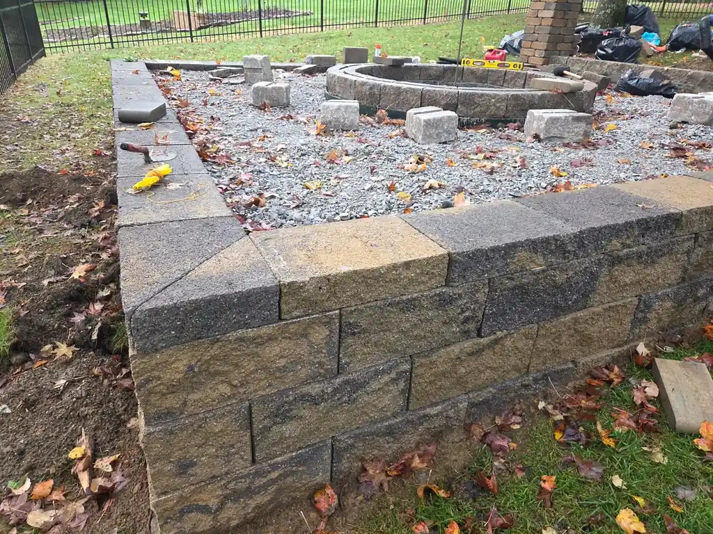 Gray block retaining wall going up in a back yard in Cleveland, Tennessee
