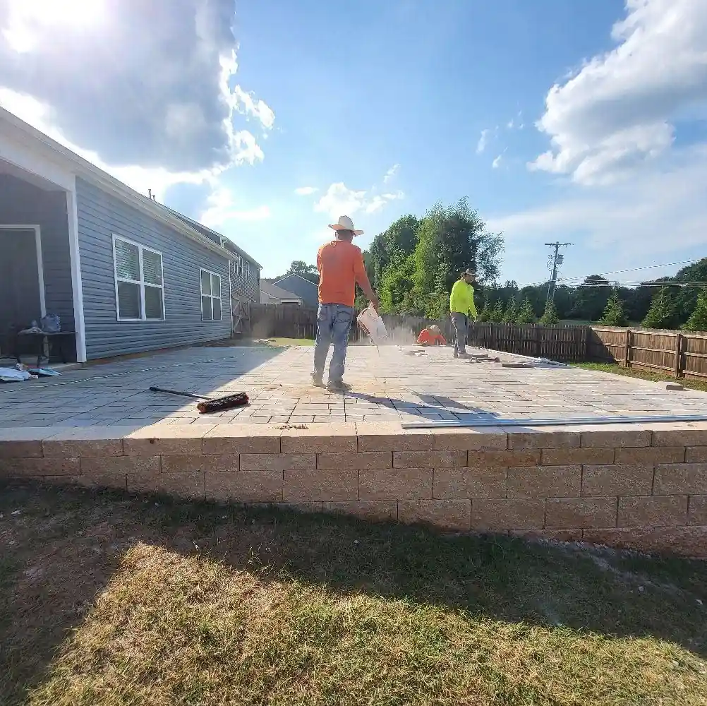 Block seat wall and paver patio finished under a blue sky in Cleveland, Tennessee